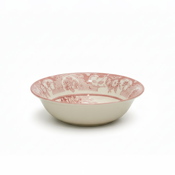 White ceramic bowl with pink floral pattern on a white background