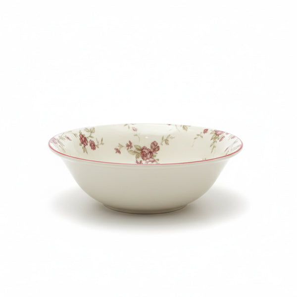White ceramic bowl with floral pattern on a white background