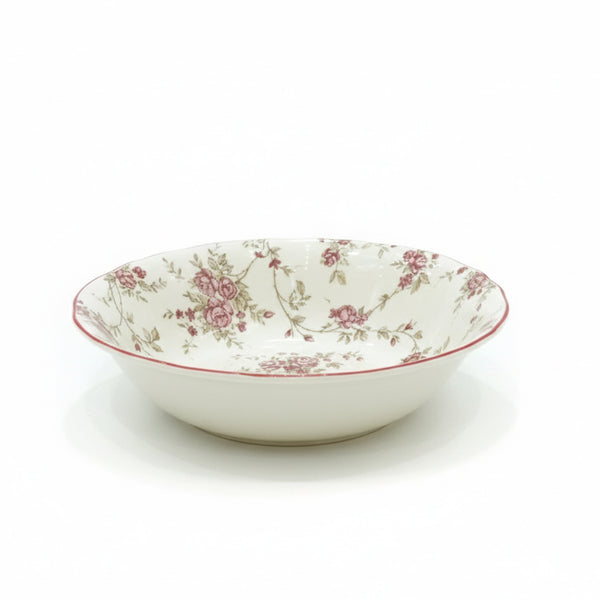 White ceramic bowl with floral pattern on a white background