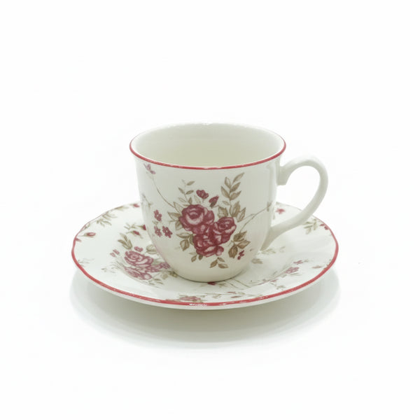 Ceramic cup and saucer with floral design on a white background