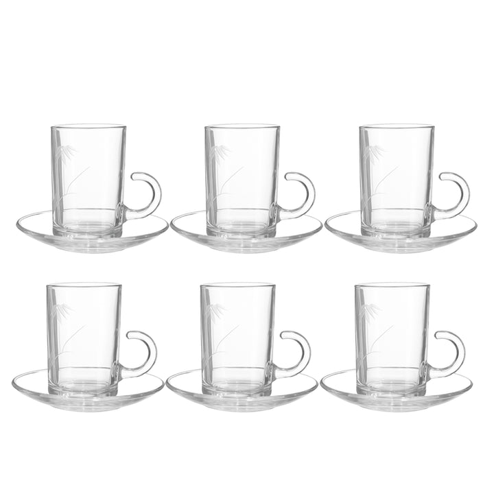 Set of six clear glass coffee cups with handles and saucers on a white background