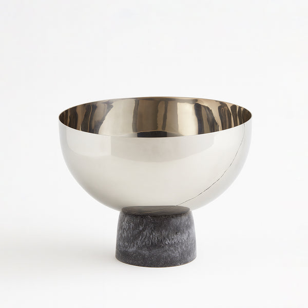 Decorative bowl with metallic top and stone base on a white background