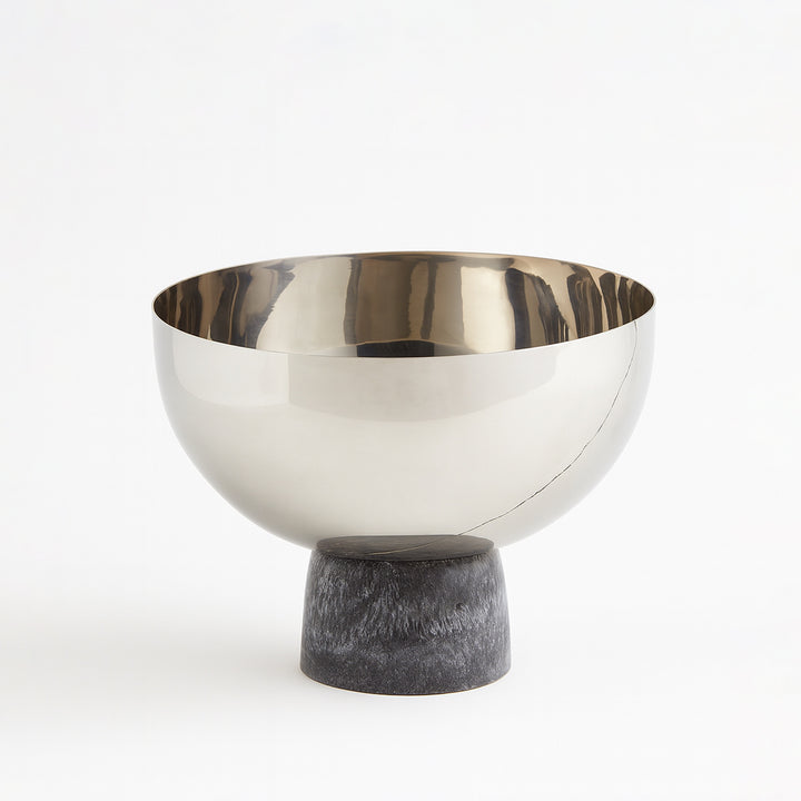 Decorative bowl with metallic top and stone base on a white background