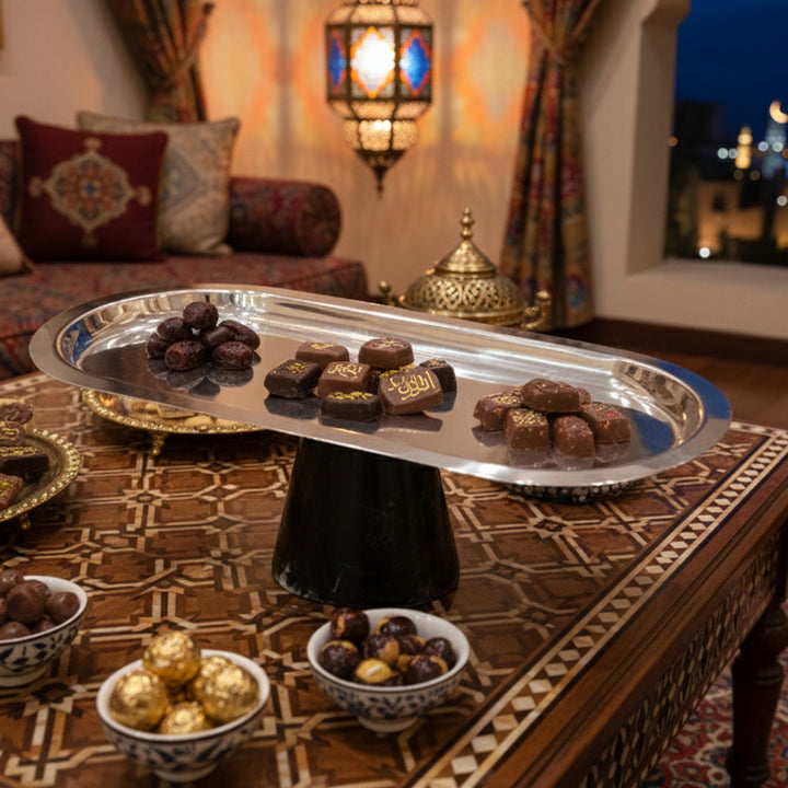 Tray of chocolates on a decorative table with a warm, cozy ambiance.