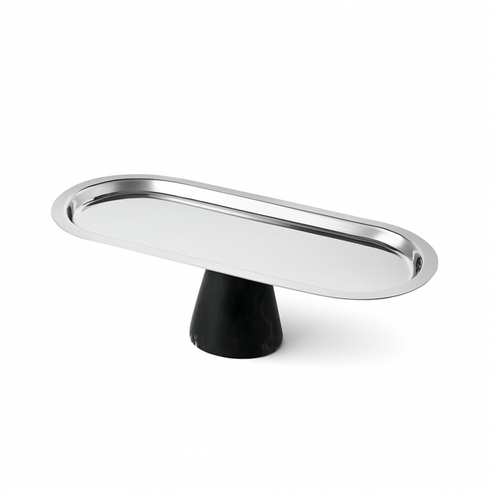 Metallic oval object on a black stand against a white background