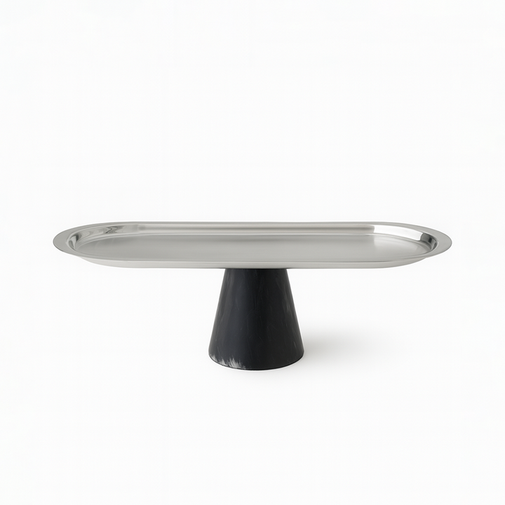 Metallic cake stand with black base on a white background