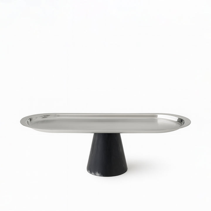Metallic cake stand with black base on a white background