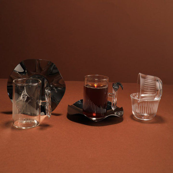Set of glassware on a brown surface with a dark background