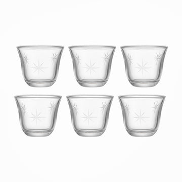 Set of six clear glass cups with star patterns on a white background