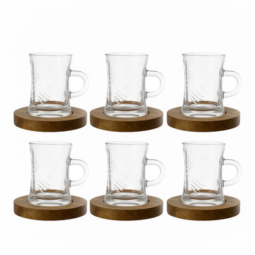 Set of six clear glass mugs with wooden coasters on a white background