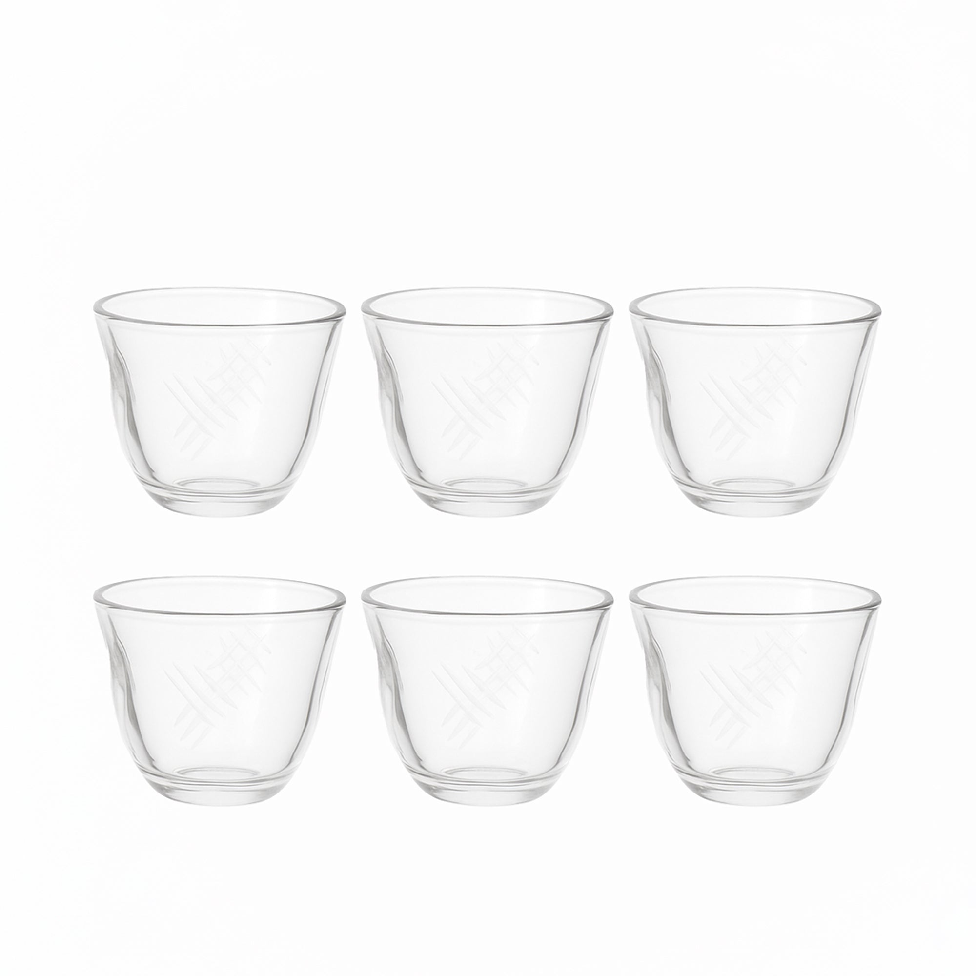 Set of six clear glass tumblers on a white background