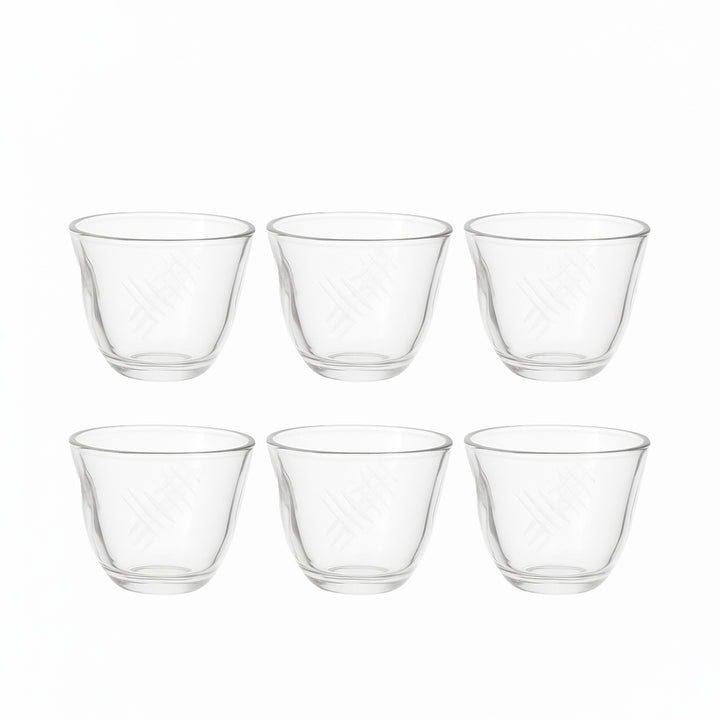 Set of six clear glass tumblers on a white background