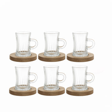 Set of six clear glass mugs with wooden coasters on a white background