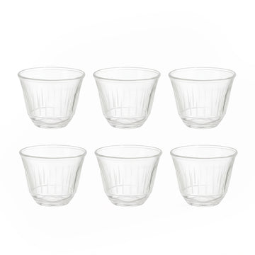 Set of six clear glass tumblers on a white background