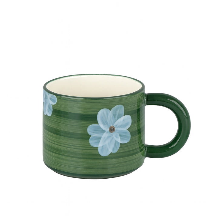 Green mug with floral design on a white background