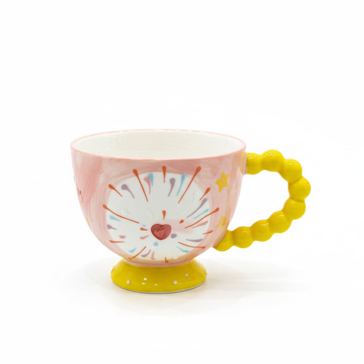 Pink mug with a yellow handle and base on a white background