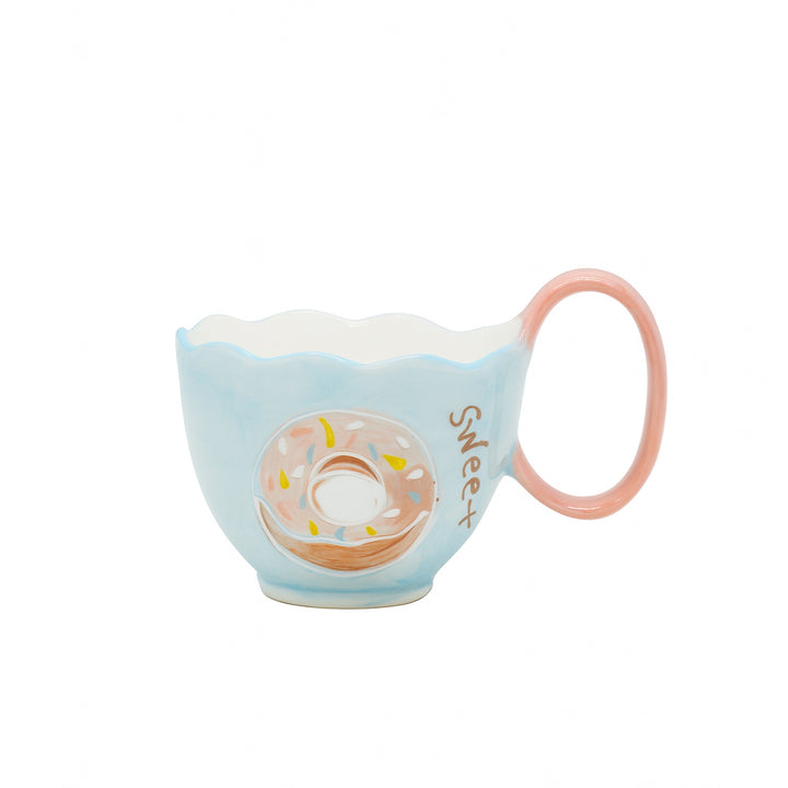 Ceramic cup with a blue and white finish featuring a pink donut illustration, “Sweet” text design, and a rounded pink handle — displayed on a white background from Siddiq Gifts, Mussafah Abu Dhabi.