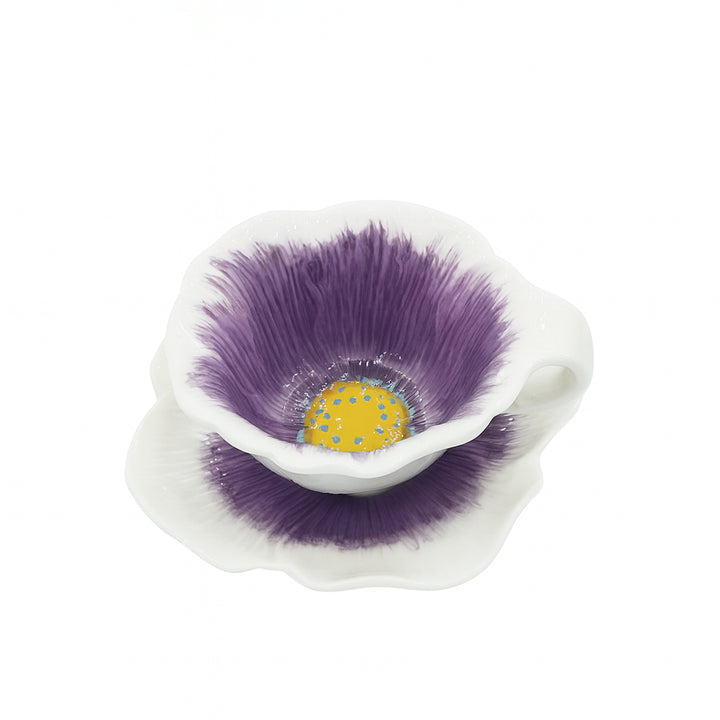 White ceramic flower with purple petals and a yellow center on a white background