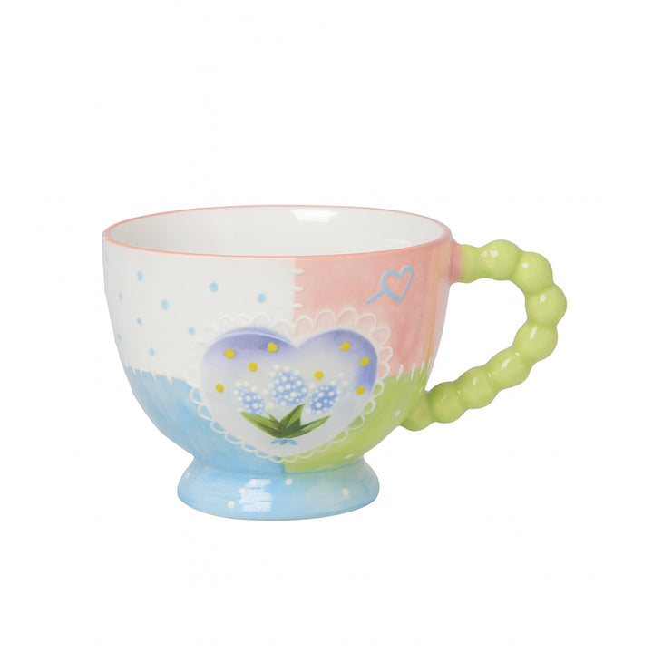 Colorful mug with heart design on a white background