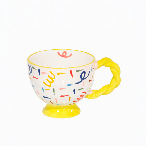 Colorful mug with a yellow handle on a white background