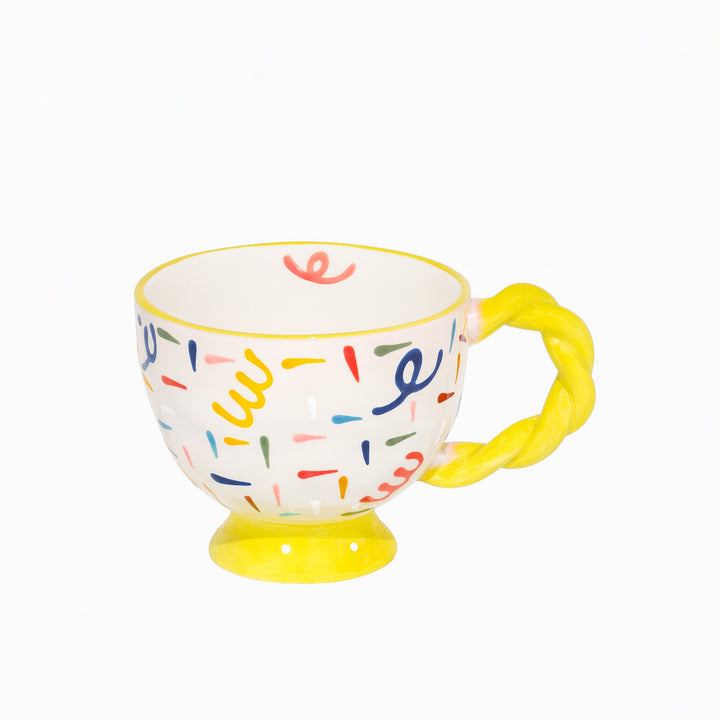 Colorful mug with a yellow handle on a white background