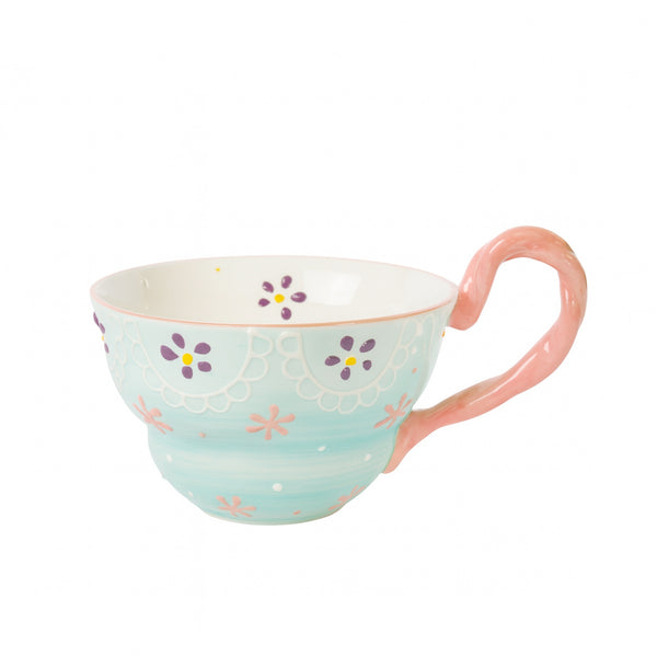 Ceramic cup with a white and pastel turquoise finish featuring multicolor floral patterns, lace-style detailing, and a twisted pink handle — displayed on a white background from Siddiq Gifts, Mussafah Abu Dhabi.