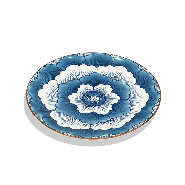 Decorative plate with blue and white floral design on a white background