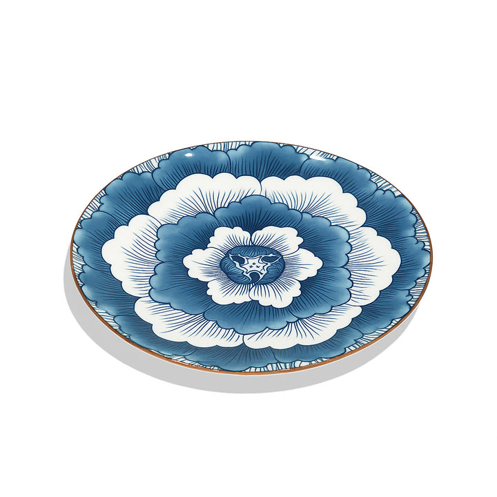 Decorative plate with blue and white floral design on a white background