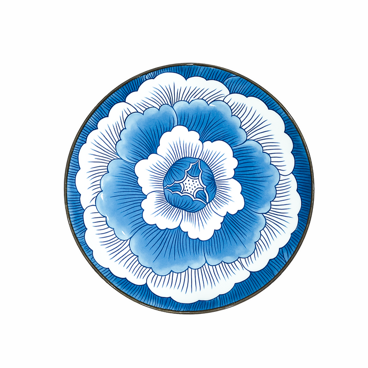 Decorative plate with blue and white floral design on a white background