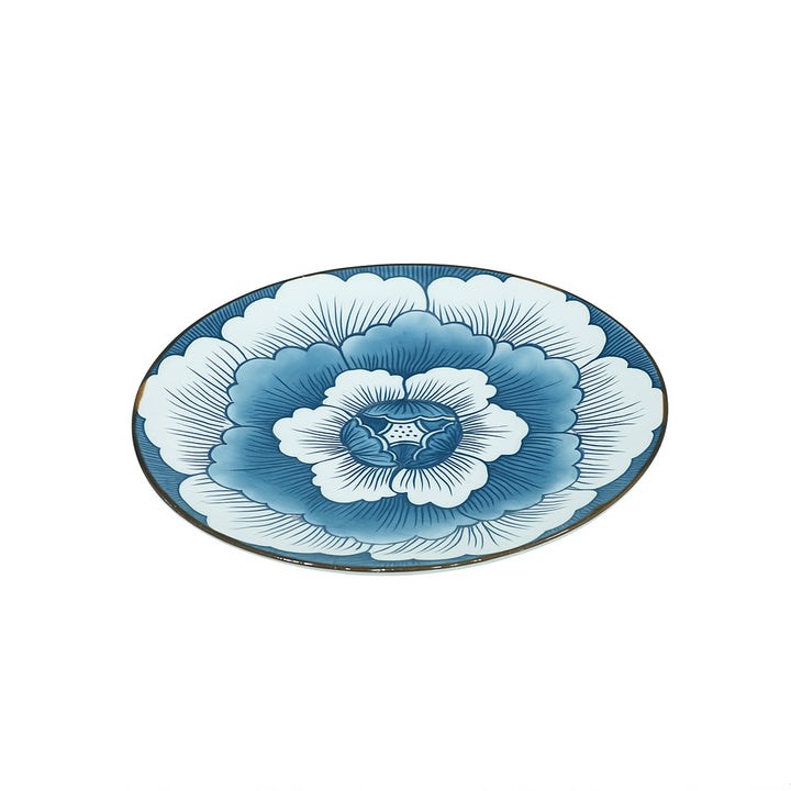 Decorative plate with blue and white floral design on a white background