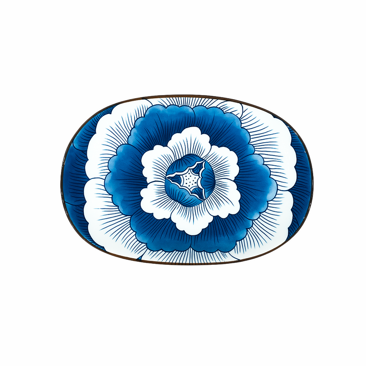 Decorative plate with blue and white floral design on a white background