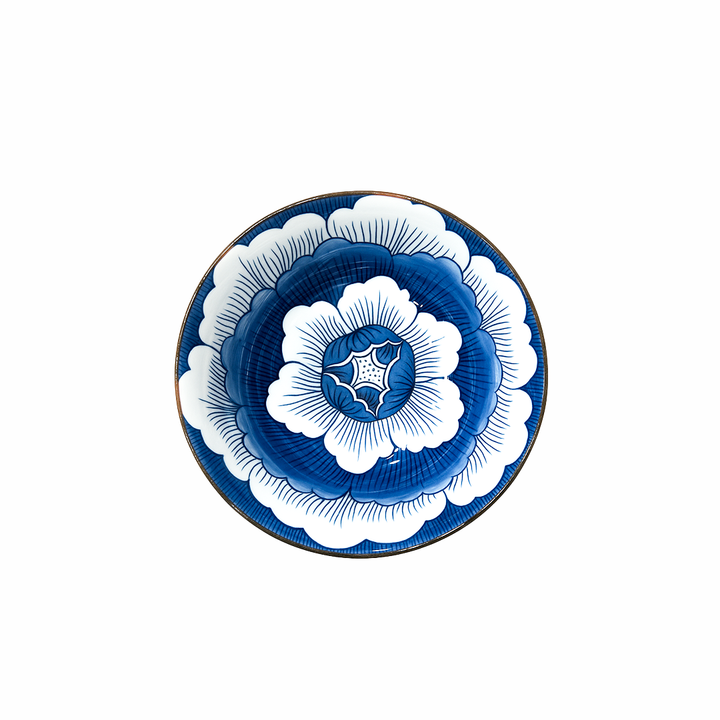 Decorative plate with blue and white floral design on a white background