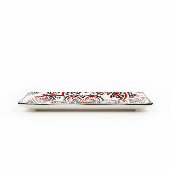 Rectangular ceramic plate with red and black pattern on a white background