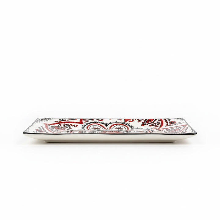 Rectangular ceramic plate with red and black pattern on a white background
