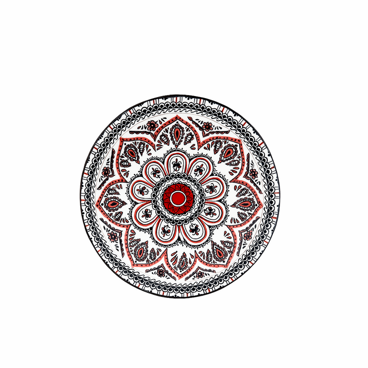 Decorative plate with a red and black mandala design on a white background