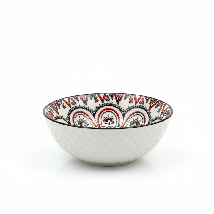 Decorative ceramic bowl with red and black patterns on a white background