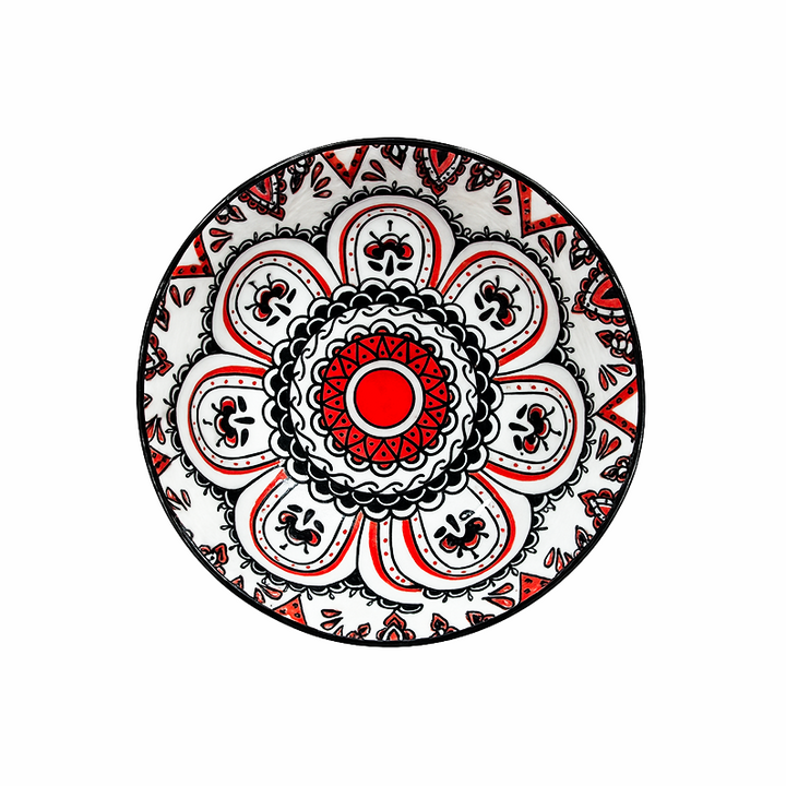 Decorative plate with a red and black geometric pattern on a white background
