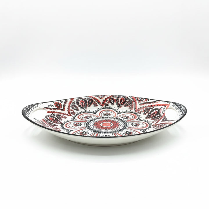 Decorative plate with red and black patterns on a white background