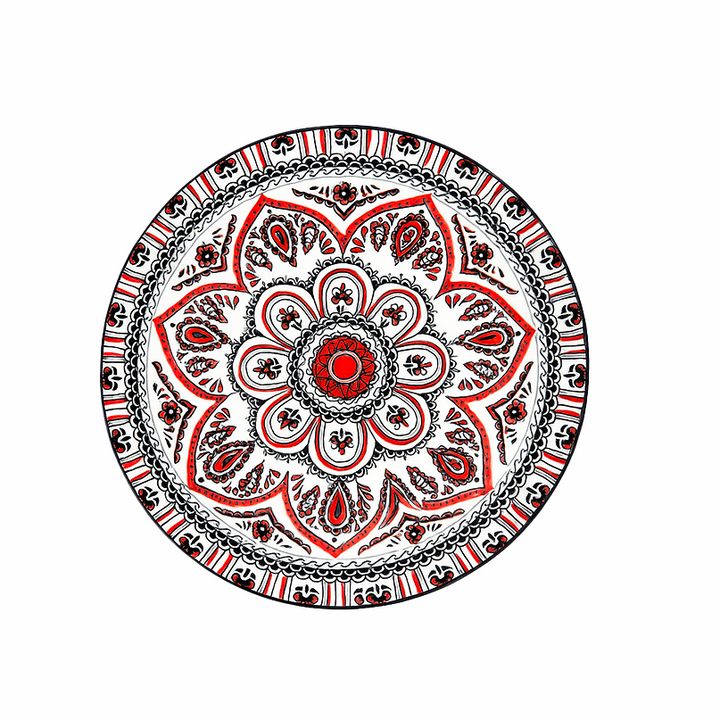 Decorative plate with a red and black mandala design on a white background