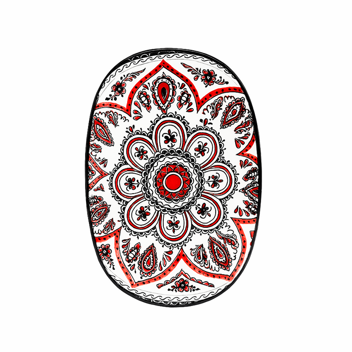 Decorative oval with red, black, and white pattern on a white background