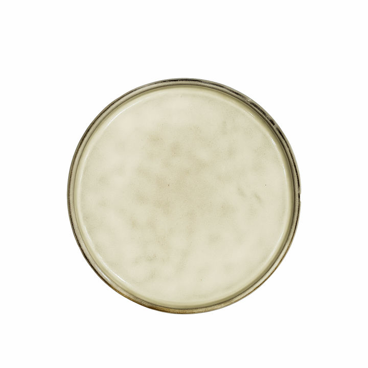 Round ceramic plate with a beige color on a white background