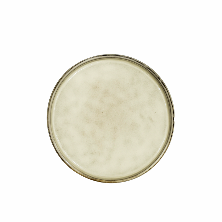 Round ceramic plate with a beige glaze on a white background