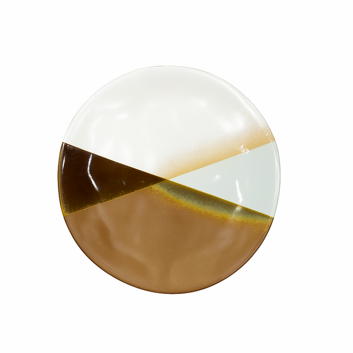 Round ceramic plate with a white and brown design on a white background
