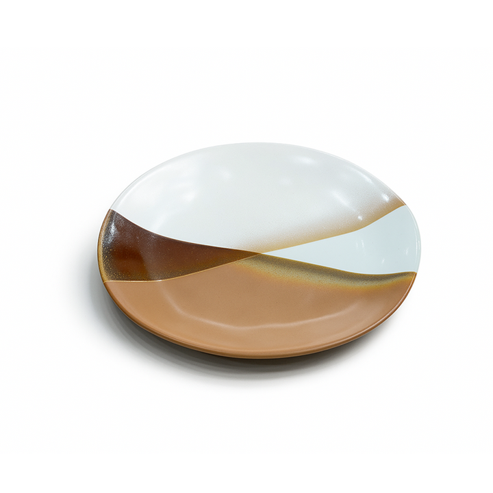 Round ceramic plate with white and brown design on a white background