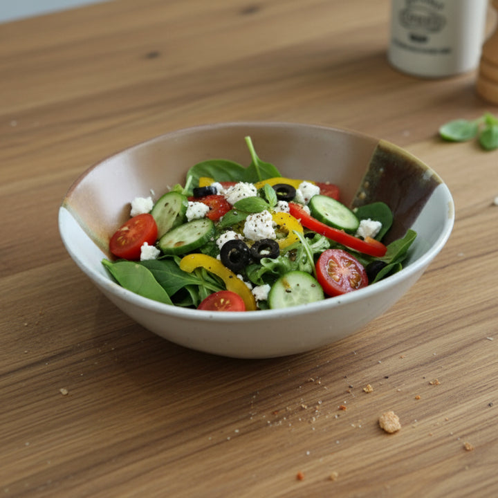 Bowl of salad with vegetables on a wooden table