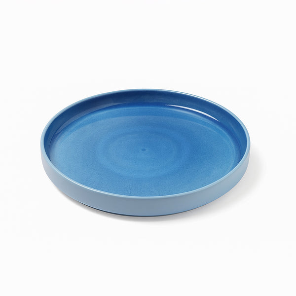 Blue ceramic plate on a white background