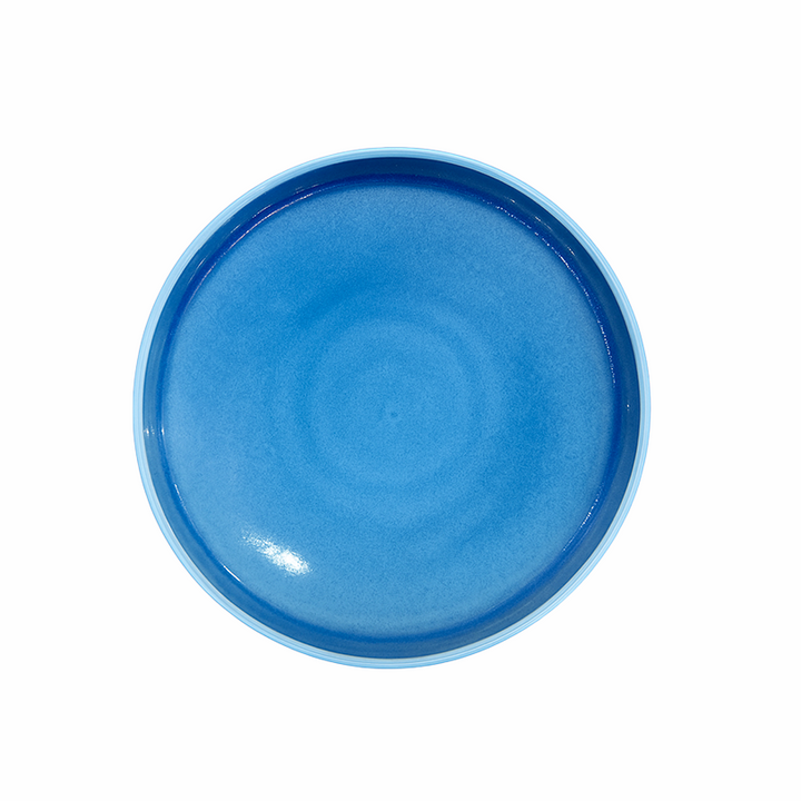 Blue ceramic plate on a white background
