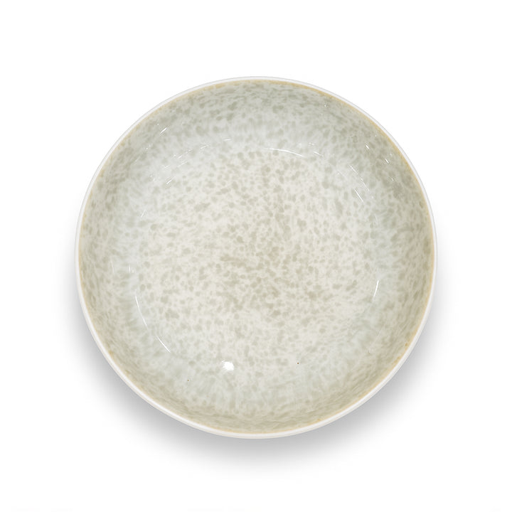 Round ceramic bowl with textured surface on a white background