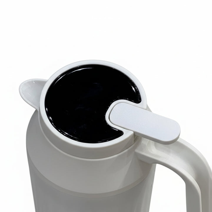 White mug with a black liquid inside on a white background