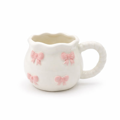 2936-20 ceramic mug in cream finish with pink bow pattern and textured handle for tea and coffee serving – Siddiq Gifts Mussafah Abu Dhabi